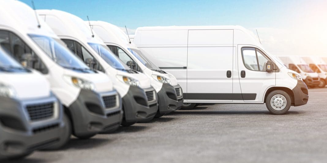 Delivery vans in a row with space for logo or text. Express delivery and shipment service concept, representing fleet insurance