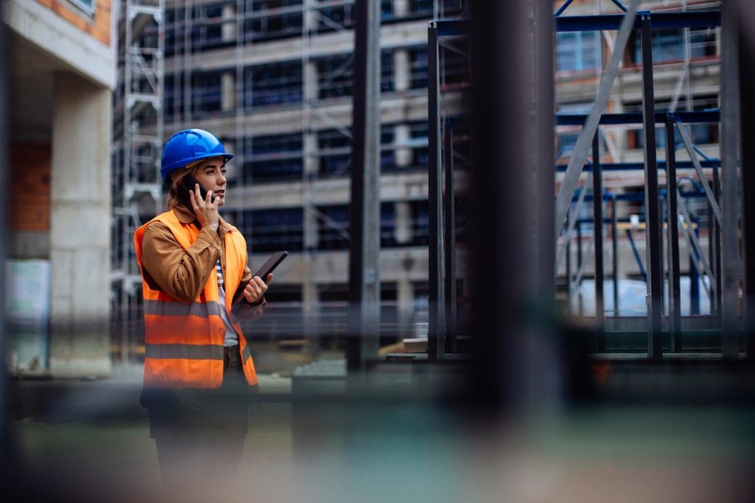 Woman at construction site, as more stability is needed in the construction industry