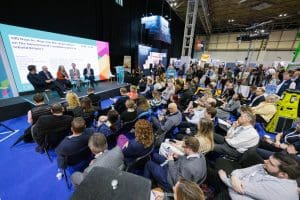 Attendees at UKCW 2024 listen to a panel discussion 