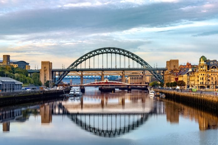 The bridges between Gateshead and Newcastle-upon-Tyne on the River Tyne lit by a stunning late summer sunrise.