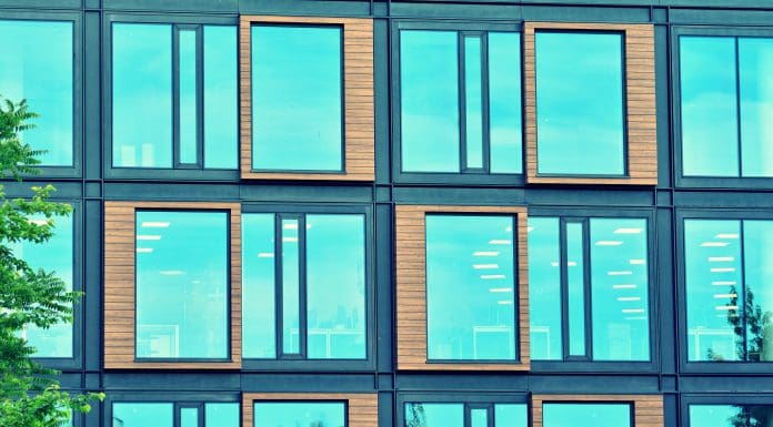 Modern office building facade abstract fragment, shiny windows in steel structure, retro stylized colorful tonal filter effect, representing climate resilient design