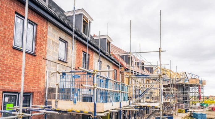 Scaffolding surrounding new homes at a development in n Cambridgeshire, South-East England, as will be covered in NHBC's BEYOND '25 LIVE