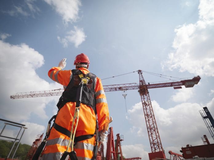 Crane Worker Directing Cranes, representing site sustainability