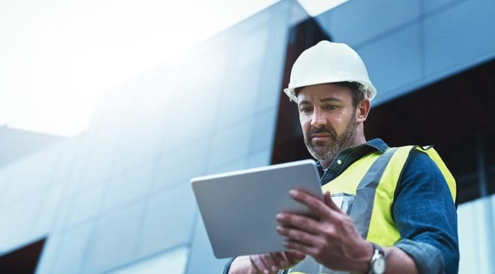 Shot of a engineer using a digital tablet on a construction site, representing issue management