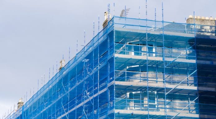 Scaffolding surrounding residential development for safe access to construction work UK, representing the building safety backlog