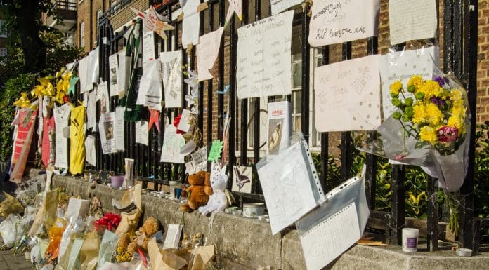 London, UK - July 5, 2017: Railings close to Grenfell Tower covered in memorials to those killed and missing. At least 80 people are thought to have died in the fire in the council tower block of flats in Kensington, London.