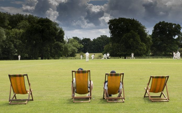 watching a cricket match on a typical English cricket ground in summer, representing changing influence of statutory consultees on planning decisions