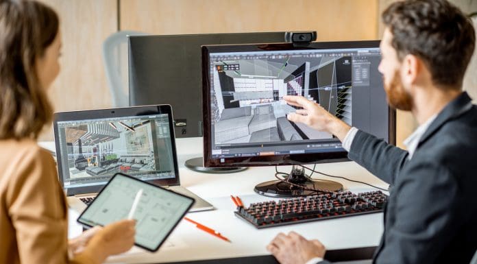 Two creative office employees making interior design on the computer and digital tablet at the modern office of architectural firm. Concept of 3d modelling and digital Interior designing, representing sustainability data