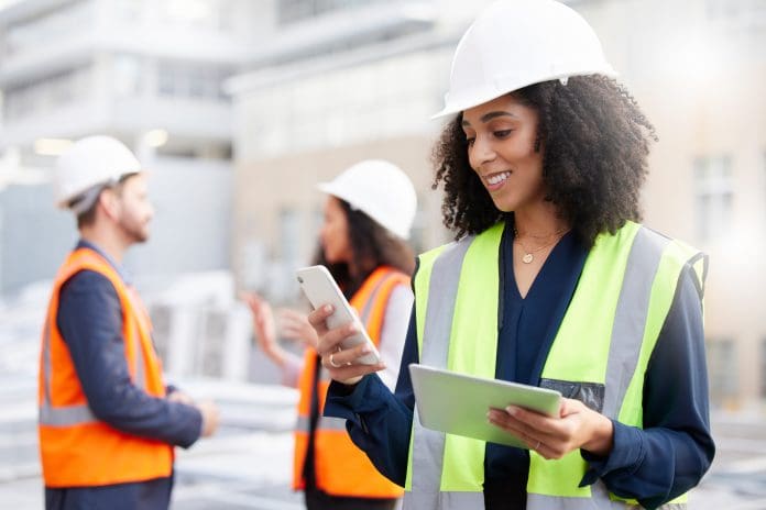 Engineering, phone and a woman outdoor for planning, search or communication. African engineer person with technology in a city for construction site, project management or app for maintenance team